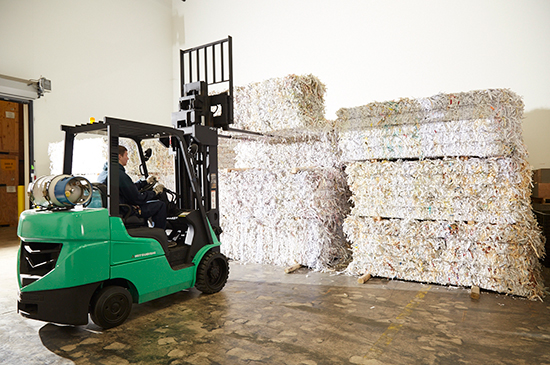 Forklift Moving Bales of Shredded Paper