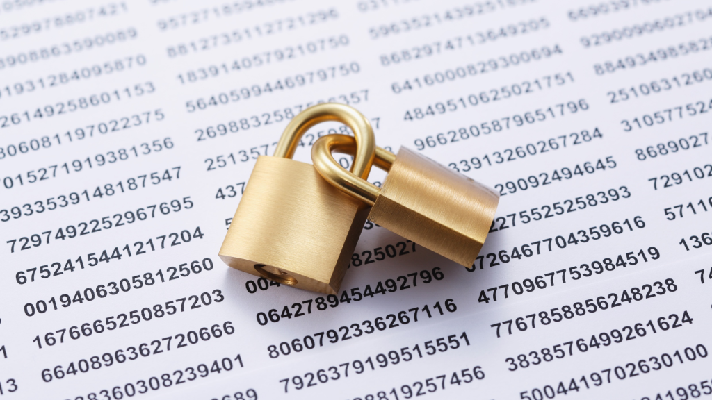 Two brass padlocks resting on a printed sheet of numbers, representing data security and confidential information protection.